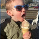 young-boy-holding-large-ice-cream-cone