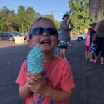 young-boy-holding-large-ice-cream-cone